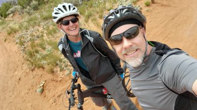 Meredith and Jason Adams mountain biking in Moab in 2024