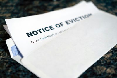 New long term rental rules in Colorado dictate the best course of action for evictions. Notice of Eviction sticking out of an envelope. Photo by Allan Vega on Unsplash